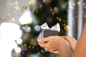 woman hands holding small gift with ribbon