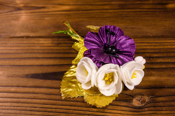 Beautiful multicolored brooch on a wooden table