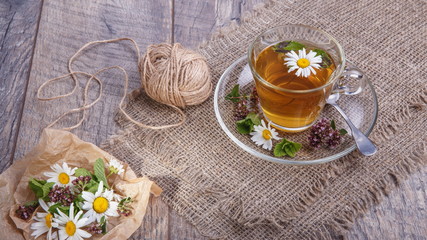 A cup of tea with chamomile on a wooden background. Alternative, traditional medicine. Healthy lifestyle