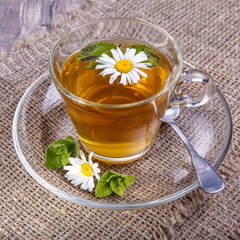 A cup of tea with chamomile on a wooden background. Alternative, traditional medicine. Healthy lifestyle