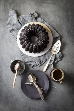 Dark chocolate bundt cake, spoons and decorative spatula