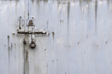 Padlock on metal door in front, copy space