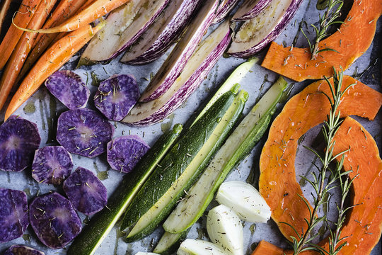Food background: chopped raw fresh vegetables on baking sheet before roasting