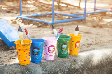 Paint brush resting in cup paint background for design,used jobs