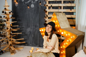 Christmas girl in interior with candles and lights