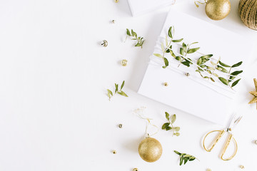 Christmas gift box decorated with green branches and Christmas balls. New Year's composition.