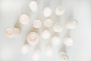 Candles collection on white background. Flat lay, top view.