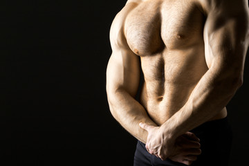 Fototapeta na wymiar Powerful muscular man holding metal workout weight