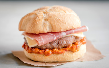 Beef burgers with prosciutto and ajvar,close up and selective focus