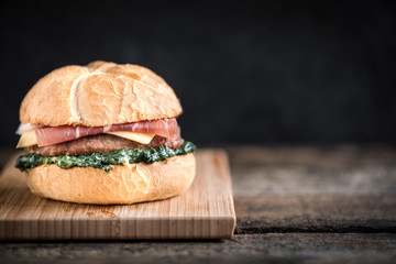 CLose up to beef burgers with spinach and prosciutto,blank space