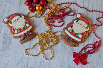 Top view on festive honey cookies in shape of Santa with different Christmas decorations