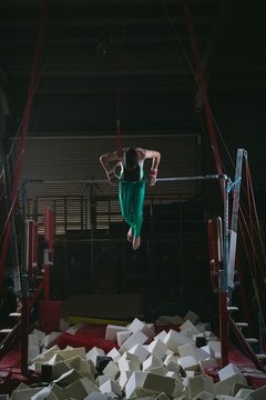 Male gymnast practicing gymnastics on the horizontal bar
