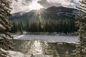 Sun shining above the Canadian Rockies in Banff