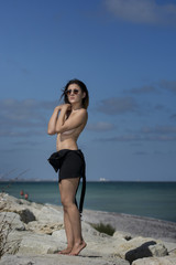 Fototapeta na wymiar Beautiful young sexy woman enjoying nature by the sea