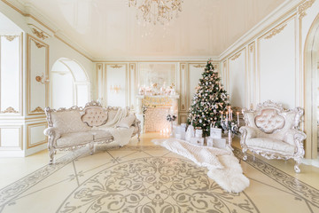 Christmas morning. luxury classic apartments with a white fireplace. © malkovkosta