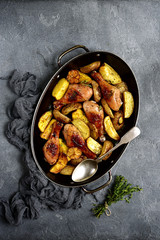 Chicken legs baked with potato.Top view.