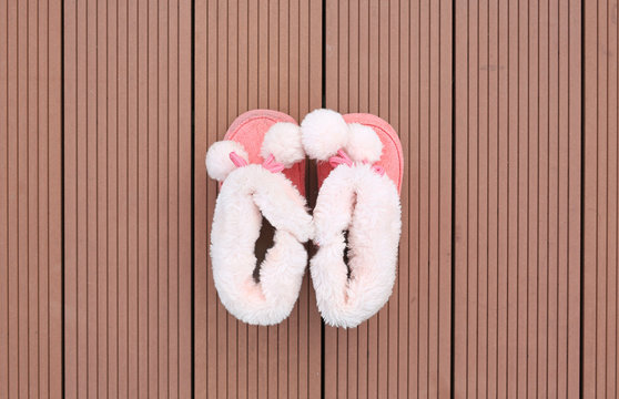 Pair of baby fashion shoe on wood plank background. Shoes for winter season.
