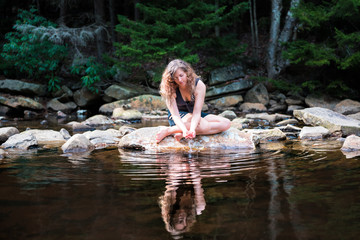 Young woman enjoying nature on peaceful, calm Red Creek river in Dolly Sods, West Virginia during...
