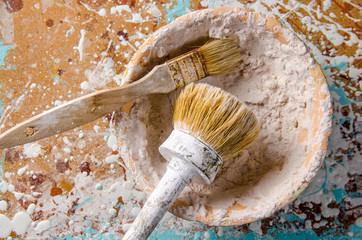brushes in a bowl with a putty
