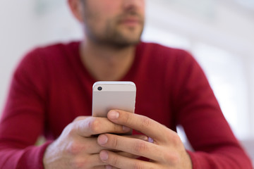 young man using a mobile phone  at home