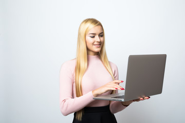 Portrait of a young happy business woman with a laptop over white