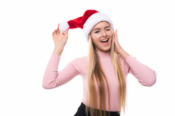 Portrait of joyful pretty woman in red santa claus hat isolated on white background. Beautiful girl looking happy and excited. Happy Christmas and New Year holidays full of fun.