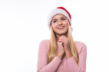 Portrait of happy excited pretty woman in santa hat on white background