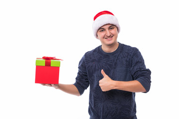 Handsome man in Christmas hat holding gift box on white background