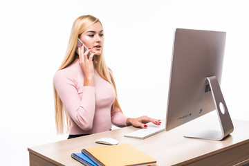 Portrait of smiling businesswoman phoning at her desk in office