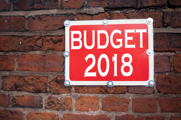 Fototapeta premium Hand writing text caption inspiration showing Budget 2018 concept meaning New Year Budget Financial Concept written on old announcement road sign with background and copy space