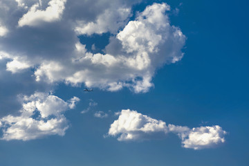 little airplane flying on the blue sky