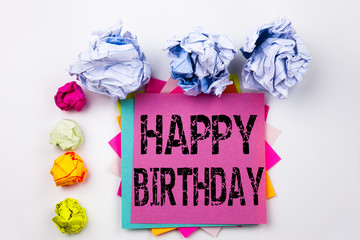 Writing text showing Happy Birthday written on sticky note in office with screw paper balls. Business concept for Anniversary Celebration on the white isolated background.