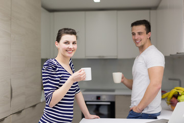 couple with laptop computer enjoying morning