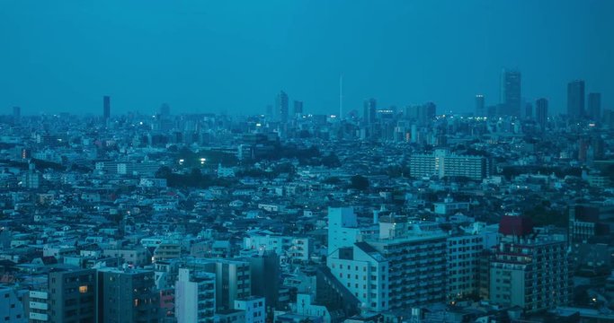TOKYO, JAPAN – JUNE 2016 : Timelapse of central Tokyo cityscape with Nakano area in view during sunset,  Day to Night transition