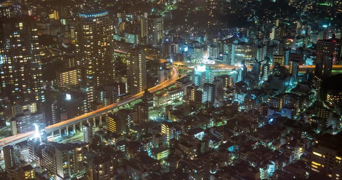 TOKYO, JAPAN – JUNE 2016 : Timelapse of downtown Tokyo at night with cityscape and traffic junction in view from Tokyo Tower