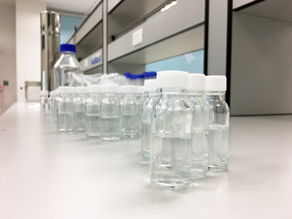 Laboratory bottles or glass bottle with pure liquid in science laboratory.