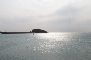 Backlit island in the sea