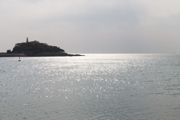 Backlit island in the sea