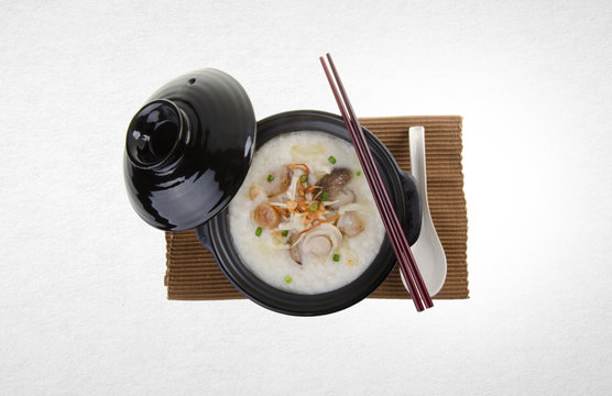 Porridge or abalone porridge in claypot on a background.