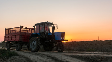 Fototapeta premium Farm tractor with a trailer