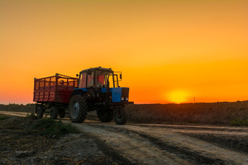 Fototapeta premium Farm tractor with a trailer