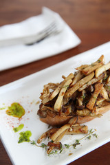 Crispy toasted white bread with mushrooms on wood background table