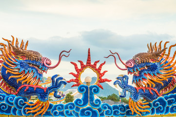 Two beautiful blue dragons. With a sky background