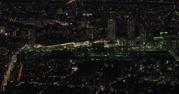 TOKYO, JAPAN – JUNE 2016 : Video shot over central Tokyo cityscape at night with river and tall buildings in view