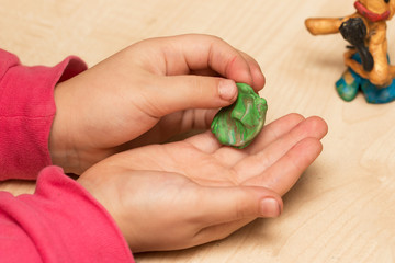children's hands playing with plasticine
