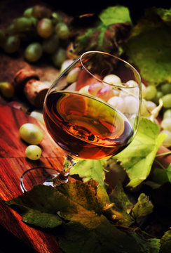 Cognac In Glass, Wine Grapes And Vine, Vintage Wood Background, Selective Focus