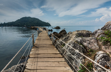       Scenic view of a long wooden bridge leading to the sea, Chanthaburi, Thailand.