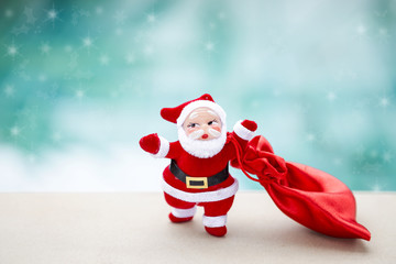 Santa Claus with fabric red bag over blurred background