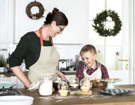 Mother and son baking for Christmas in the kitchen - Powered by Adobe