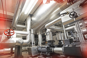 Equipment, cables and piping as found inside of a modern industrial power plant